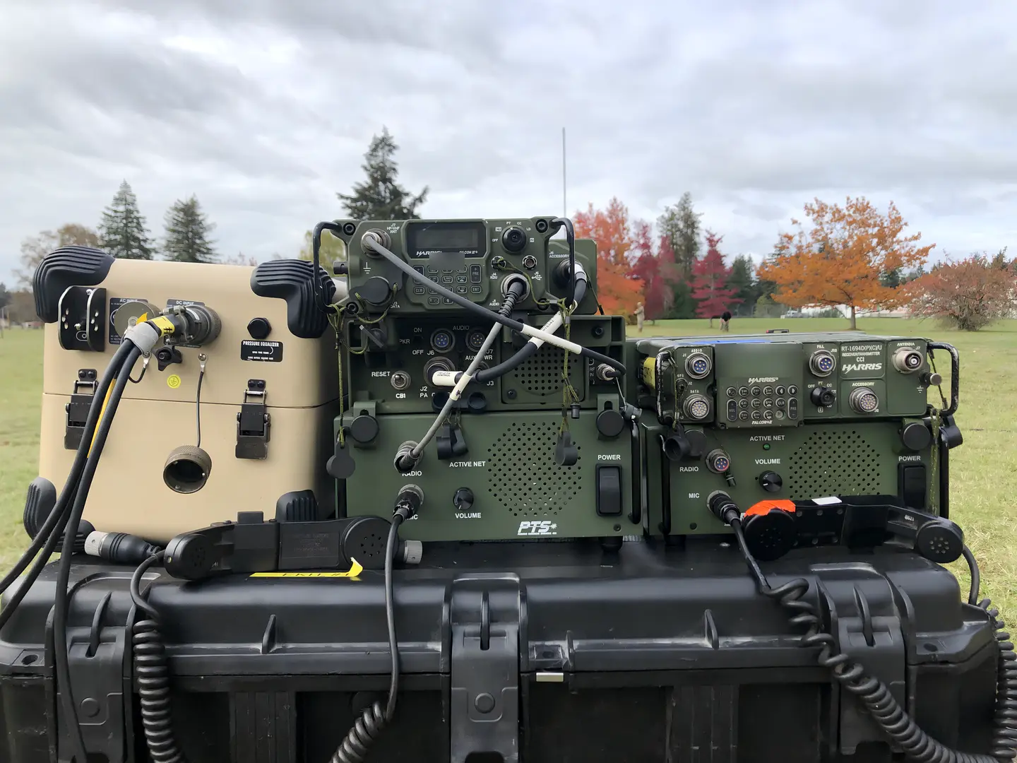 PTS docking stations powering HF and multiband tactical radios on a transit case