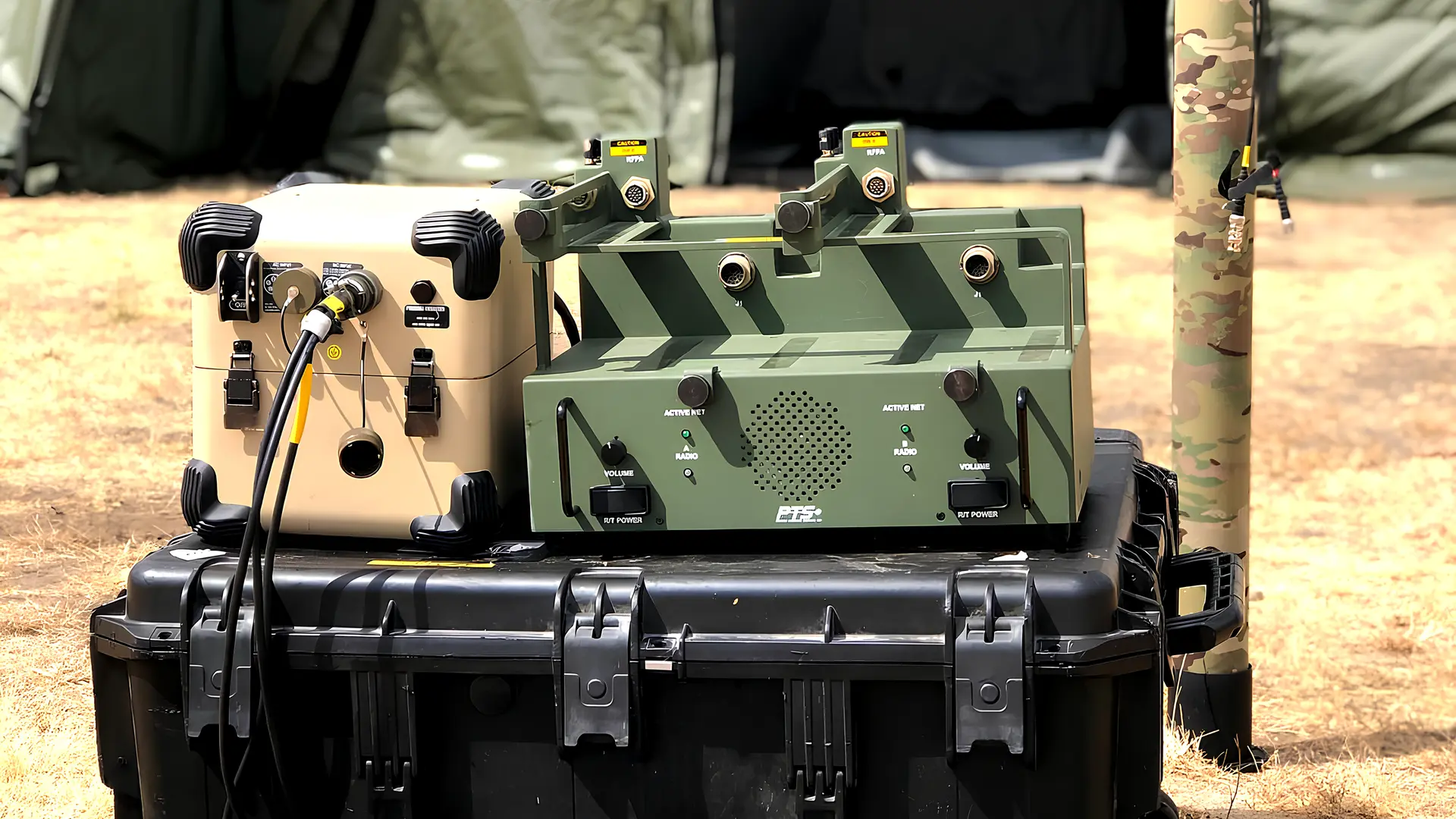 Battery replacement unit and docking station staged on a transit case with tactical solar panels outside field shelters